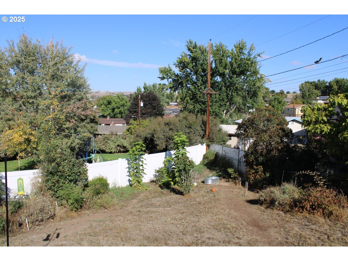 3307 Southwest Kirk Avenue Pendleton, OR 97801 - Photo 6 of 28 a view of a yard with plants and a bench