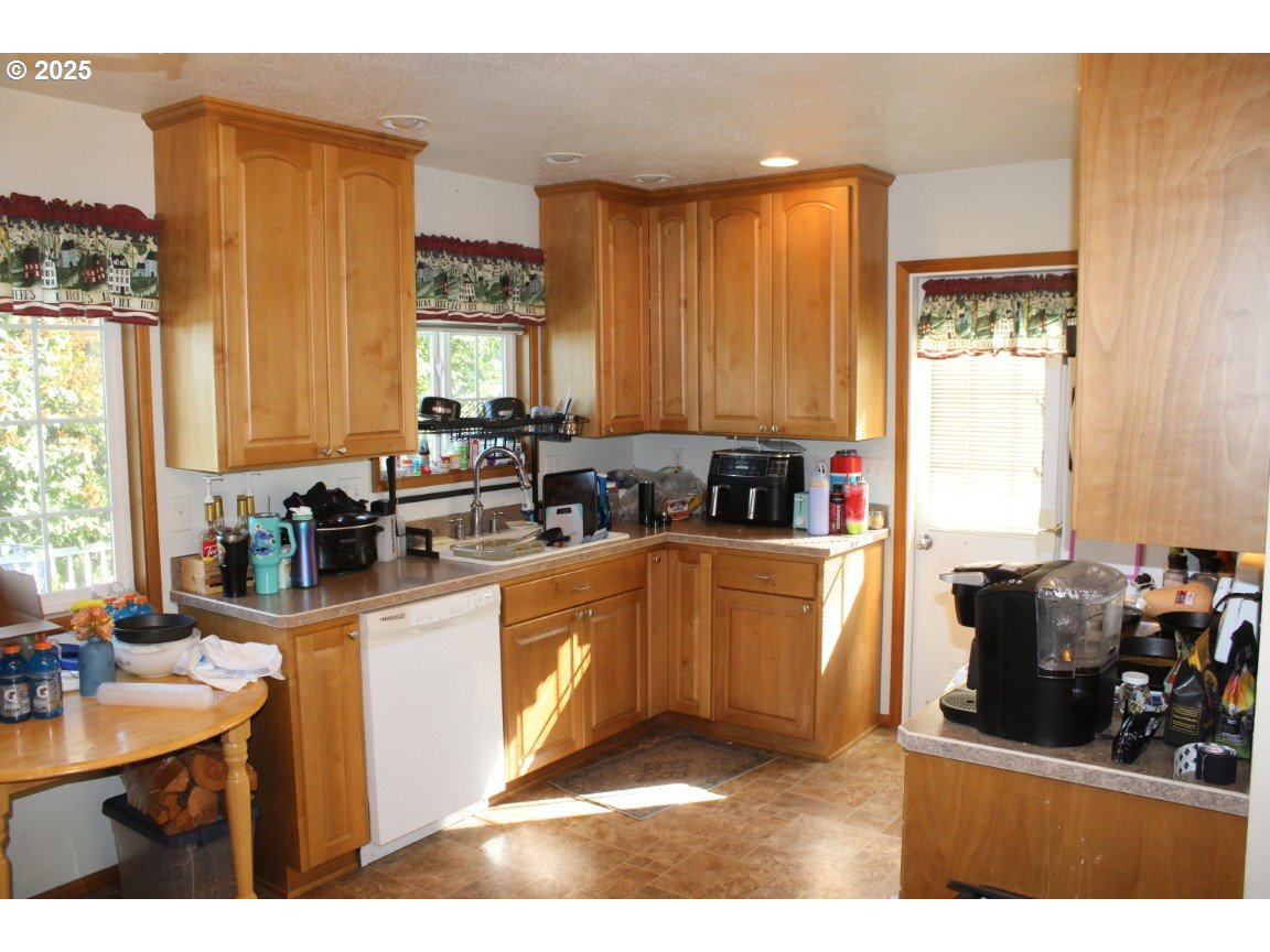 3307 Southwest Kirk Avenue Pendleton, OR 97801 - Photo 9 of 28 a kitchen with sink a window and cabinets
