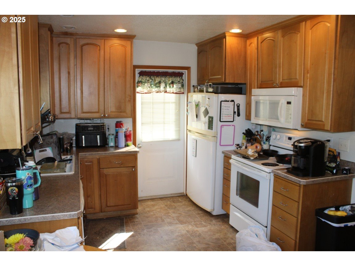 3307 Southwest Kirk Avenue Pendleton, OR 97801 - Photo 10 of 28 a kitchen with a refrigerator and a stove top oven