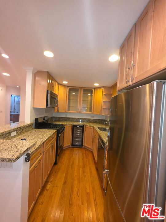 309 Broadway Street, Unit 6 Venice, CA 90291 - Photo 12 of 28 a kitchen with stainless steel appliances granite countertop a refrigerator a stove and a sink