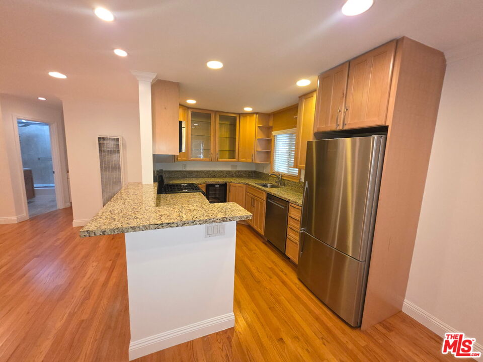 309 Broadway Street, Unit 6 Venice, CA 90291 - Photo 22 of 28 a kitchen with stainless steel appliances granite countertop a refrigerator a sink and a stove