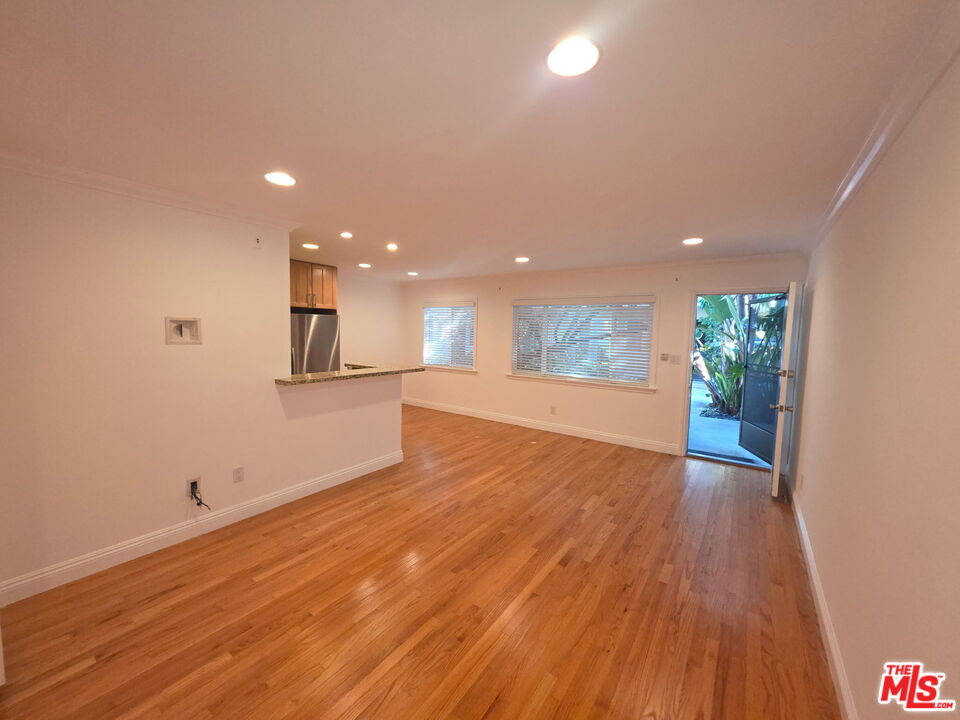 309 Broadway Street, Unit 6 Venice, CA 90291 - Photo 27 of 28 a view of an empty room with wooden floor and kitchen space
