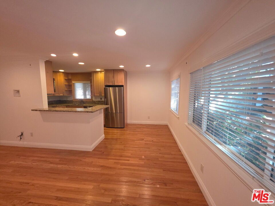 309 Broadway Street, Unit 6 Venice, CA 90291 - Photo 3 of 28 a view of kitchen with kitchen island wooden floor window and stainless steel appliances