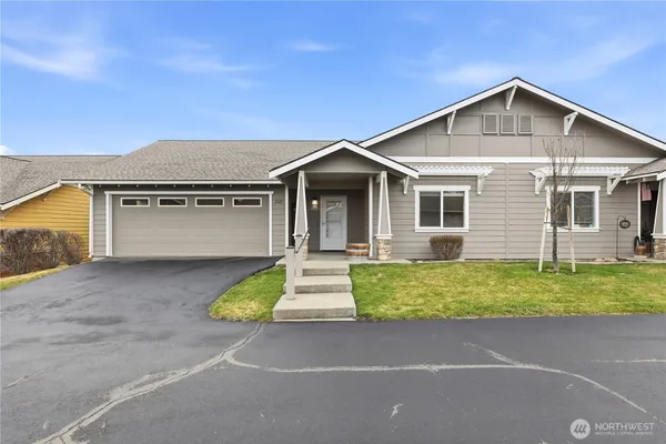 a front view of a house with a yard garage and outdoor seating