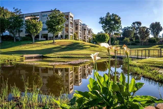 a view of a tennis ground with large trees