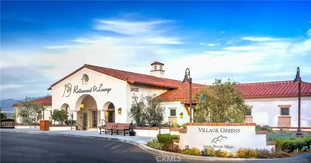 a view of a white building with a swimming pool