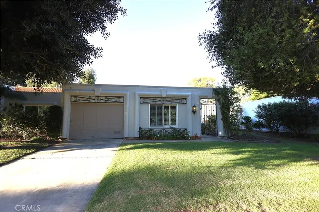 a view of a house with a yard and tree s