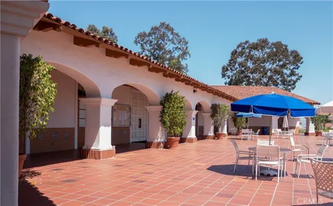 a patio with a table and chairs under an umbrella