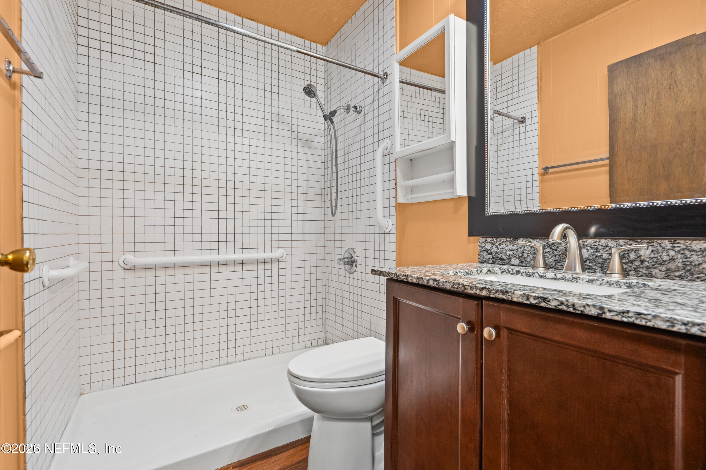 253 Cowry Road St. Augustine, FL 32086 - Photo 16 of 27 a bathroom with a granite countertop toilet sink and mirror