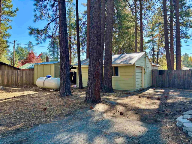 a view of backyard with trees and outdoor seating