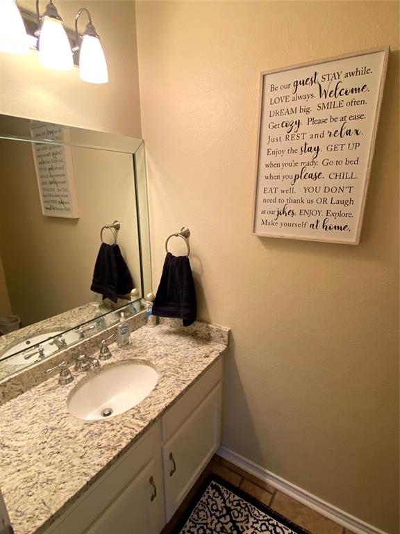 3325 Bristol Road Fort Worth, TX 76107 - Photo 8 of 26 a bathroom with a granite countertop sink and vanity
