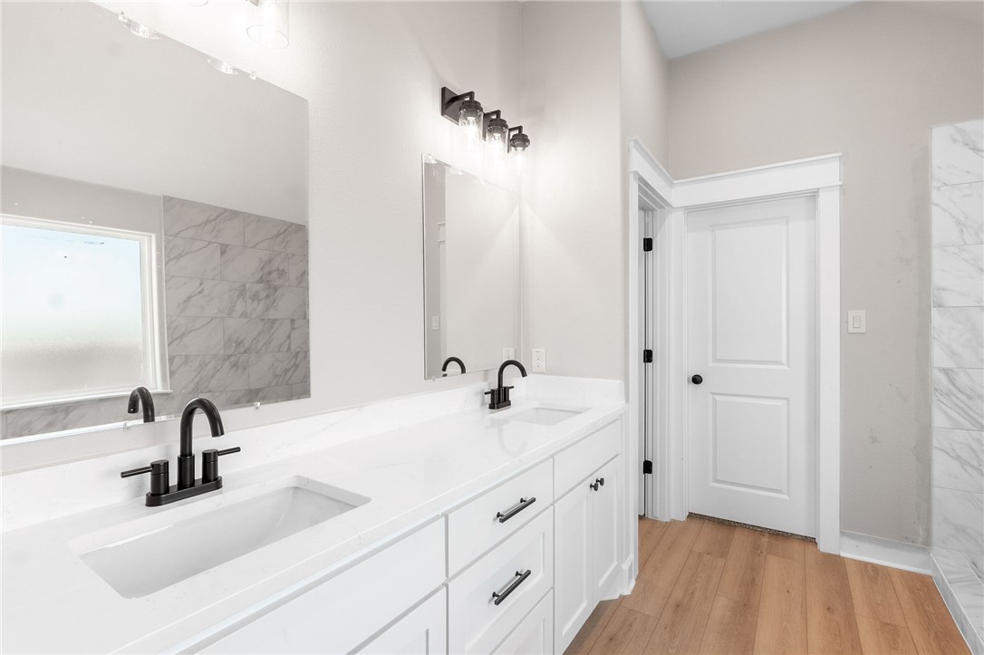 497 Combine Road Snook, TX 77879 - Photo 9 of 27 a bathroom with a double vanity sink