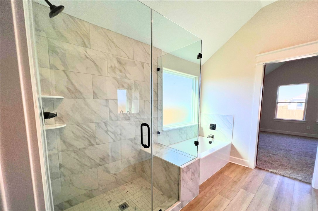 497 Combine Road Snook, TX 77879 - Photo 10 of 27 a bathroom with a bathtub a sink and a mirror