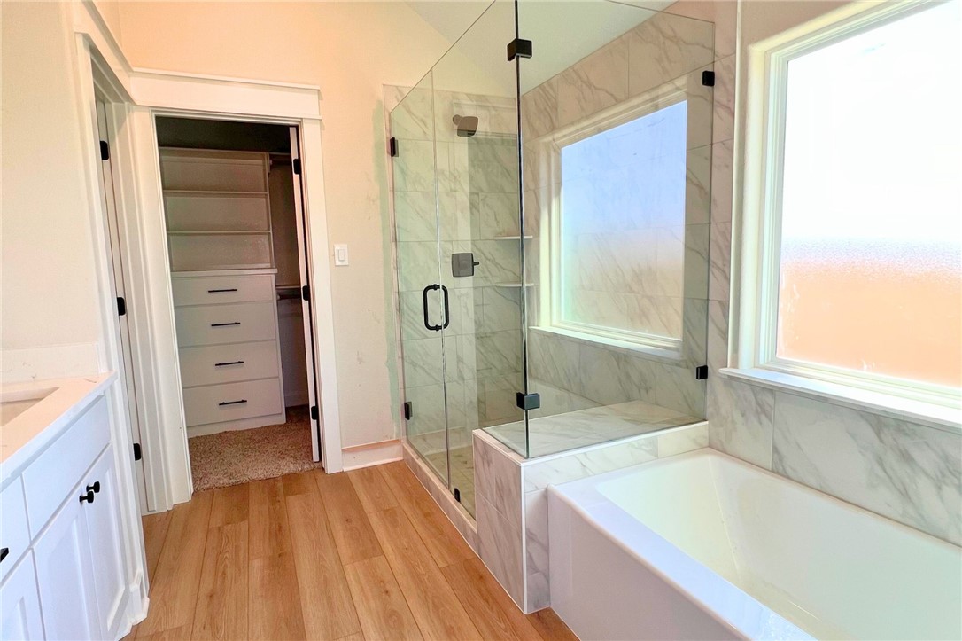 497 Combine Road Snook, TX 77879 - Photo 11 of 27 a bathroom with a bathtub and a shower