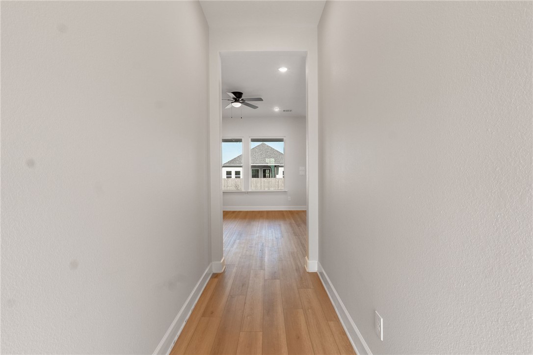 497 Combine Road Snook, TX 77879 - Photo 3 of 27 a view of a hallway with wooden floor