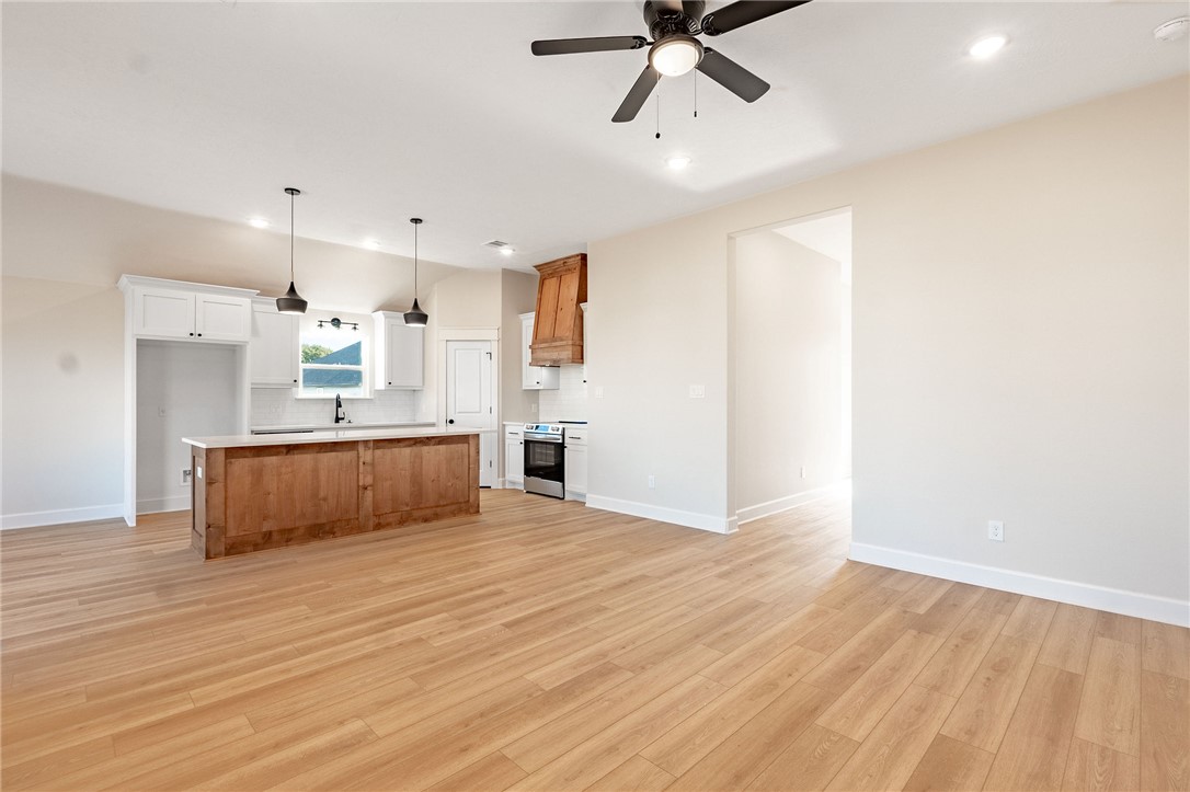 497 Combine Road Snook, TX 77879 - Photo 26 of 27 a large kitchen with a wooden floor and a kitchen view