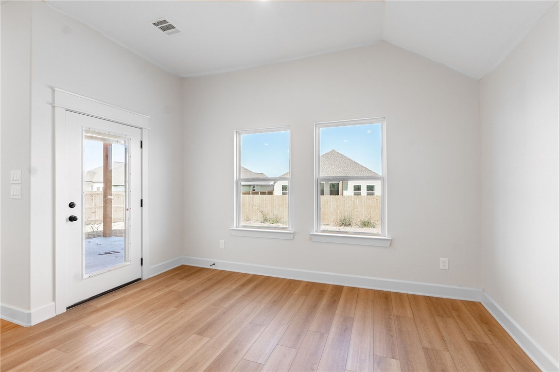 497 Combine Road Snook, TX 77879 - Photo 4 of 27 an empty room with wooden floor and windows