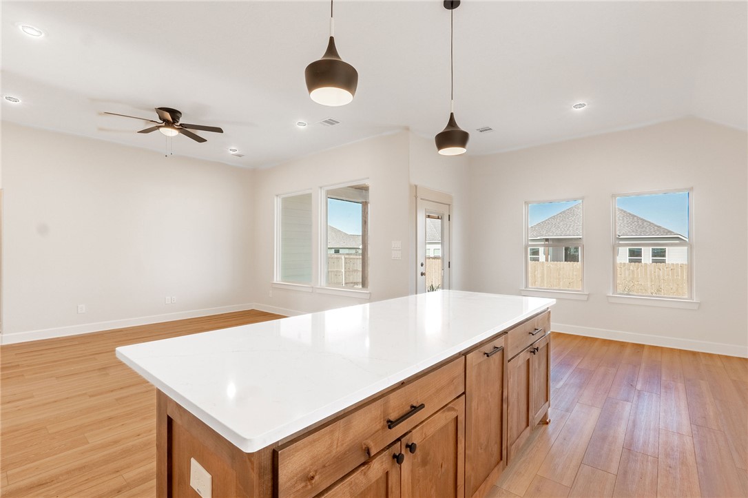 497 Combine Road Snook, TX 77879 - Photo 6 of 27 a room with a chandelier furniture and wooden floor