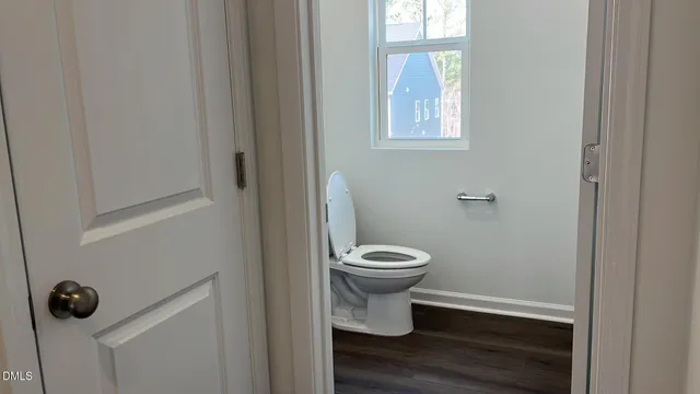 a white toilet sitting next to a bathroom sink