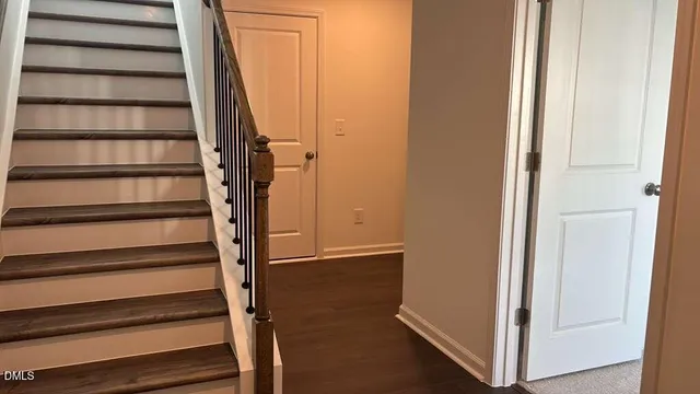 a view of entryway with wooden floor and staircase