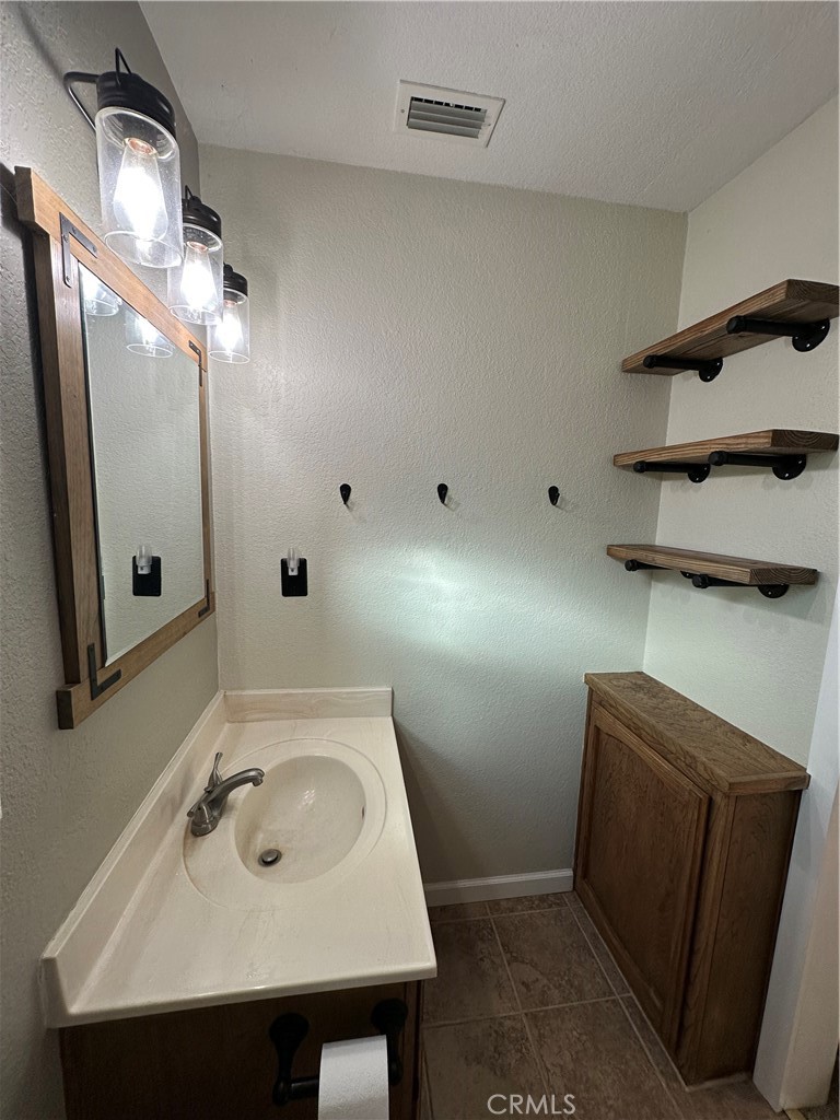 15609 Spunky Canyon Road Green Valley, CA 91390 - Photo 18 of 29 a bathroom with a sink and mirror