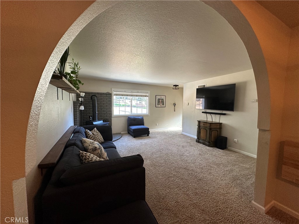 15609 Spunky Canyon Road Green Valley, CA 91390 - Photo 4 of 29 a living room with furniture and a flat screen tv