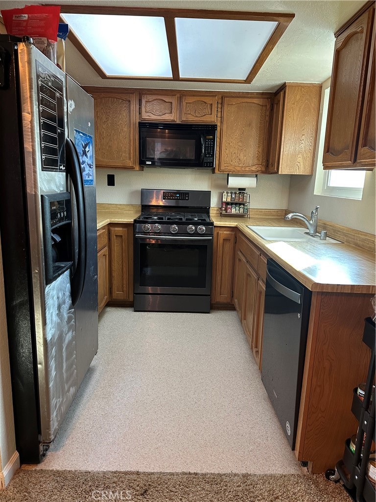 15609 Spunky Canyon Road Green Valley, CA 91390 - Photo 7 of 29 a kitchen with stainless steel appliances granite countertop a stove a sink and a refrigerator