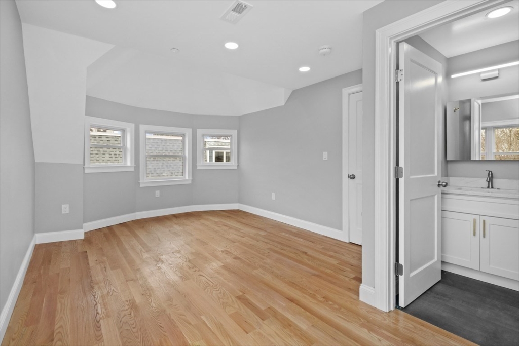 66 Stanley Street Boston, MA 02125 - Photo 15 of 42 a view of empty room with wooden floor and fan