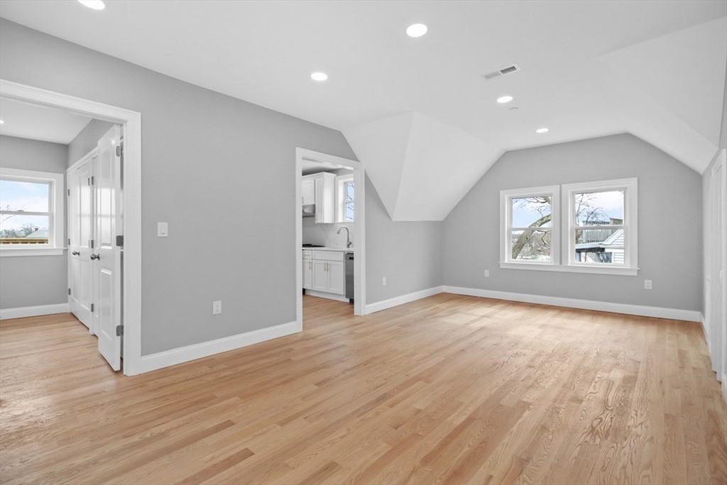 66 Stanley Street Boston, MA 02125 - Photo 16 of 42 wooden floor in an empty room with a window
