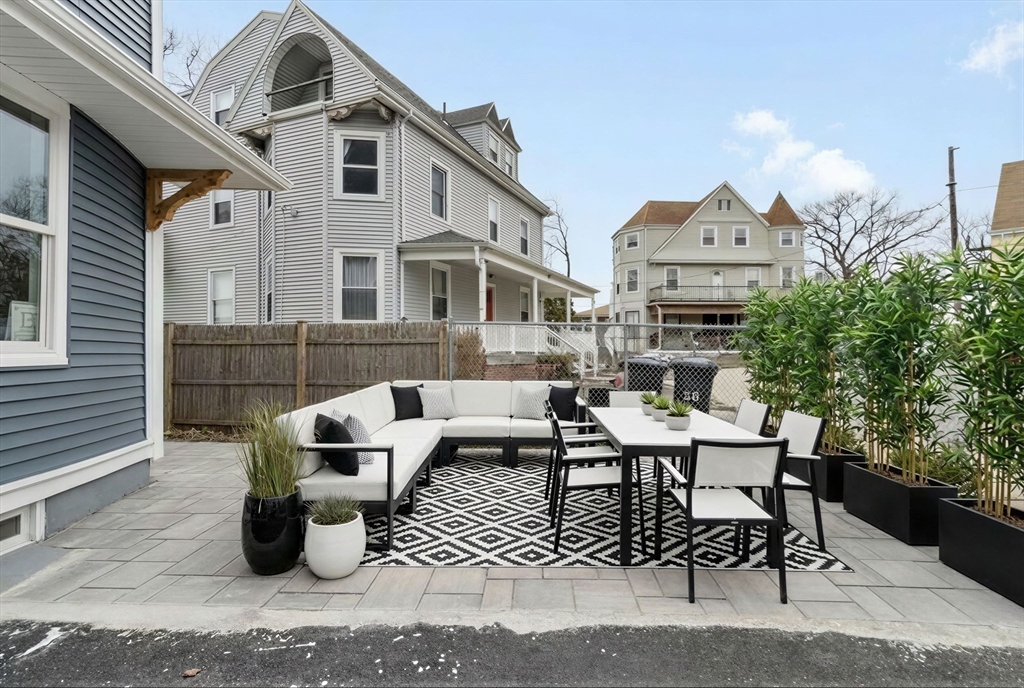66 Stanley Street Boston, MA 02125 - Photo 24 of 42 a view of a patio with couches table and chairs and potted plants