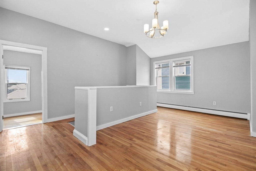 66 Stanley Street Boston, MA 02125 - Photo 30 of 42 wooden floor in an empty room with a window