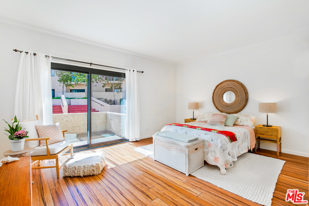 8180 Manitoba Street, Unit 124 Playa del Rey, CA 90293 - Photo 12 of 30 a bedroom with a bed and wooden floor