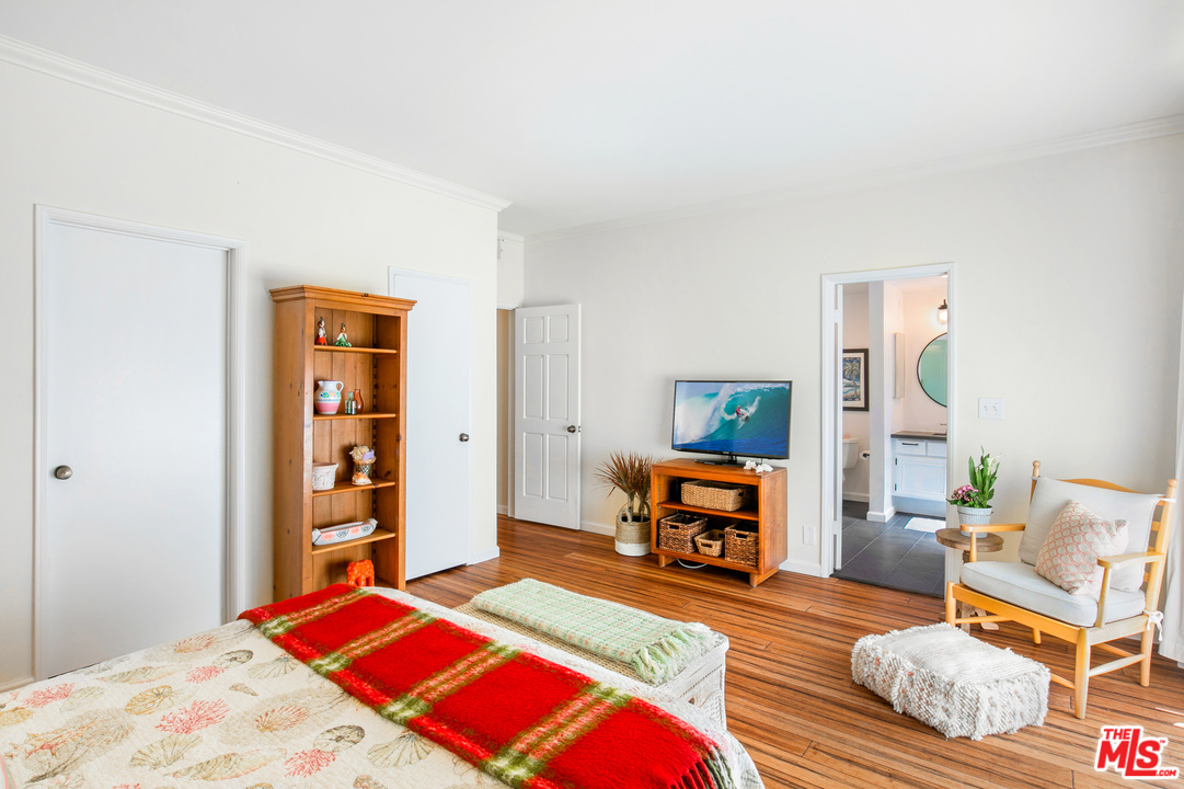 8180 Manitoba Street, Unit 124 Playa del Rey, CA 90293 - Photo 13 of 30 a bedroom with a bed a dresser and book shelf