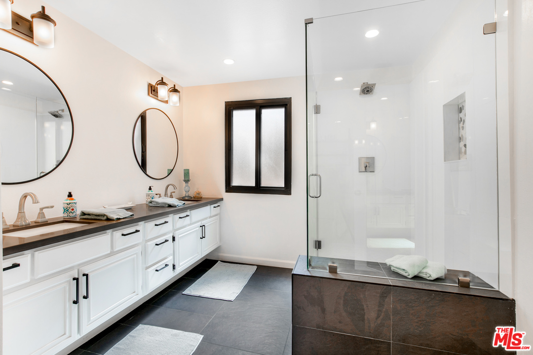 8180 Manitoba Street, Unit 124 Playa del Rey, CA 90293 - Photo 15 of 30 a bathroom with a granite countertop double vanity and mirror