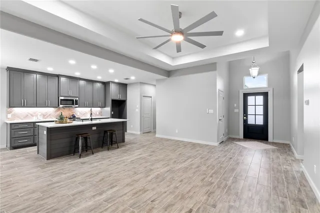 an empty room with fan and a ceiling fan