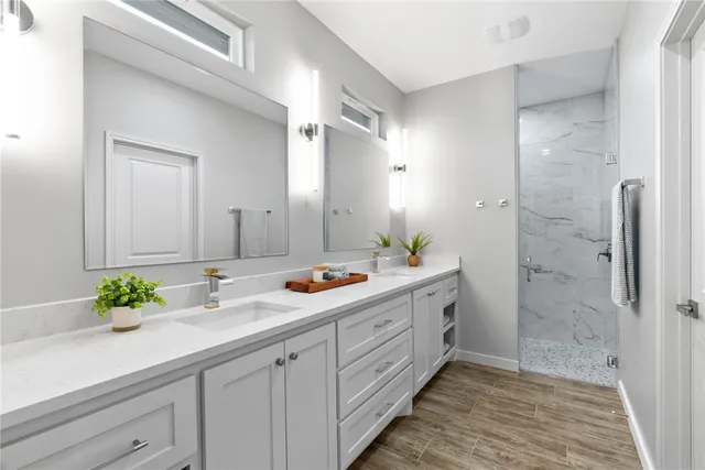 a bathroom with a double vanity sink and a mirror