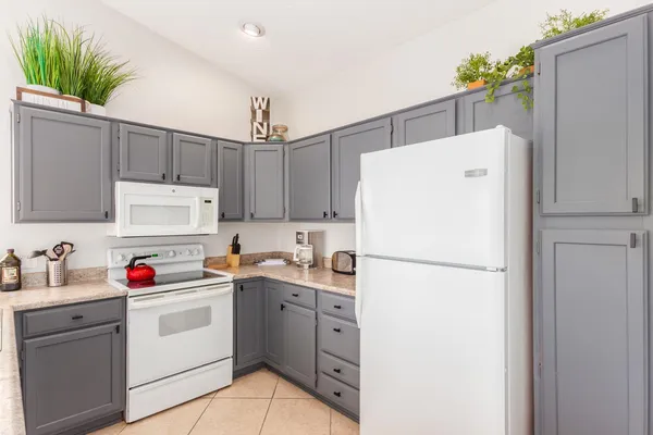 a white refrigerator freezer sitting in a kitchen