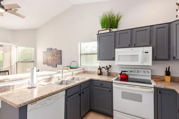 a kitchen with a sink cabinets and window