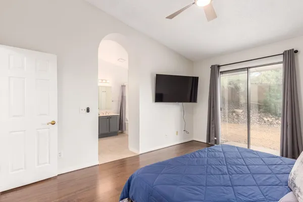 a bedroom with a bed and a flat screen tv