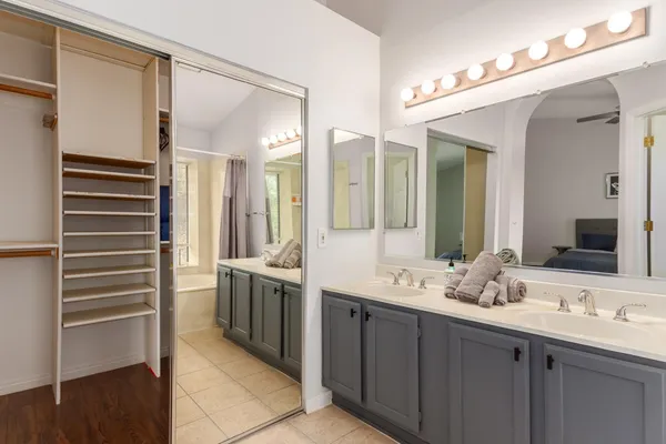 a bathroom with a double vanity sink and a mirror