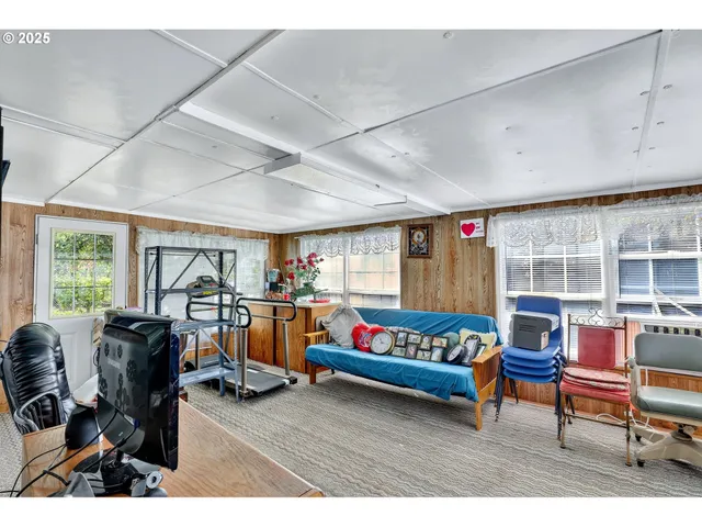 a living room with furniture a rug and a large window