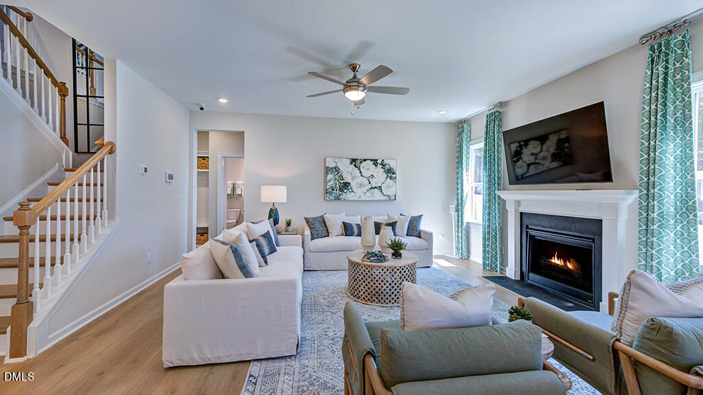 151 Rivulet Court Cary, NC 27519 - Photo 11 of 37 a living room with furniture a flat screen tv and a fireplace