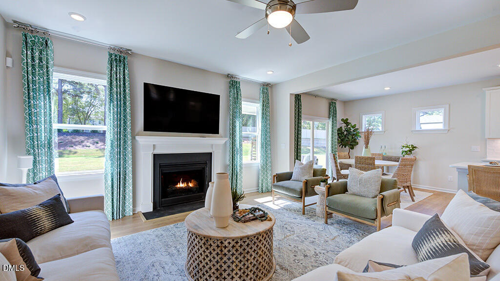 151 Rivulet Court Cary, NC 27519 - Photo 12 of 37 a living room with furniture a flat screen tv and a fireplace