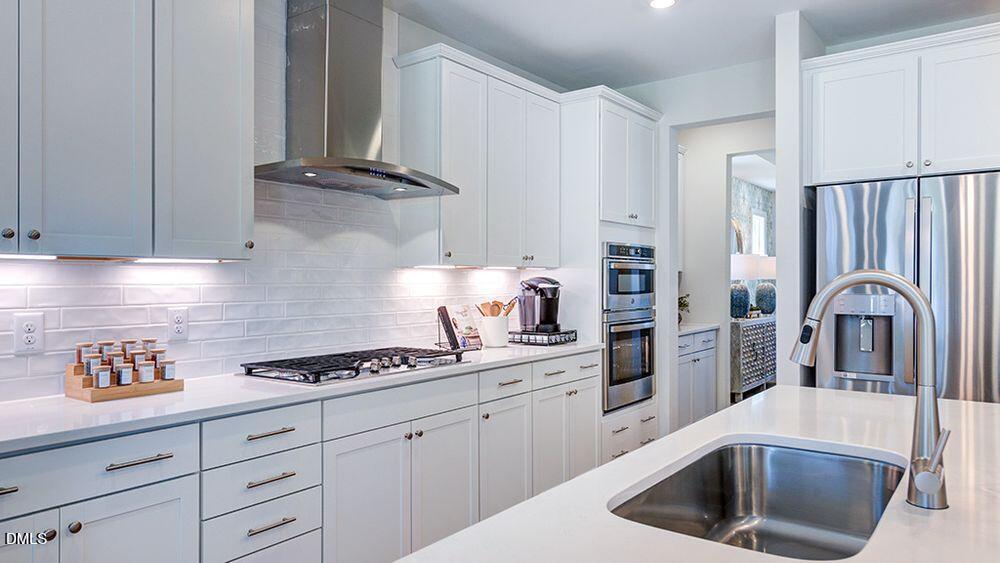 151 Rivulet Court Cary, NC 27519 - Photo 17 of 37 a kitchen with stainless steel appliances granite countertop a sink stove and cabinets
