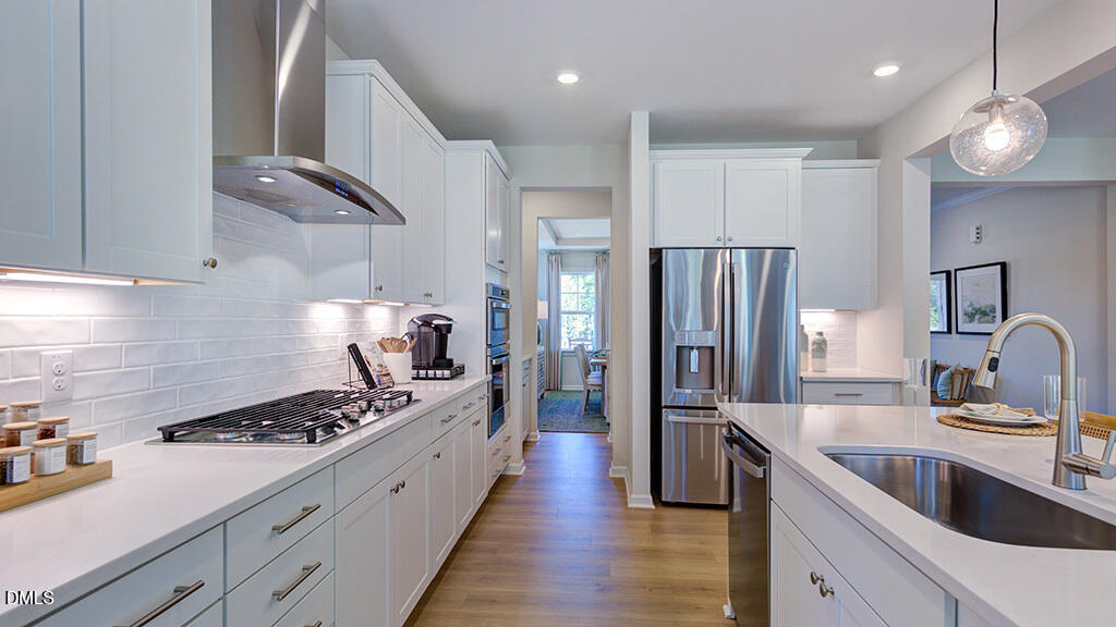 151 Rivulet Court Cary, NC 27519 - Photo 18 of 37 a kitchen with stainless steel appliances a sink stove and refrigerator
