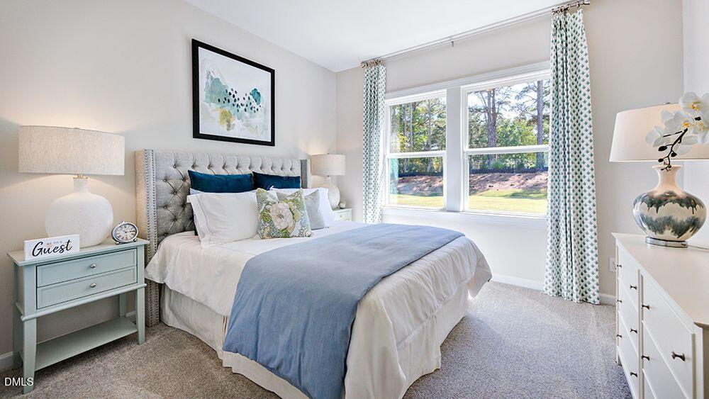 151 Rivulet Court Cary, NC 27519 - Photo 23 of 37 a bedroom with a bed and a painting on the wall