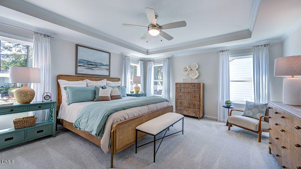 151 Rivulet Court Cary, NC 27519 - Photo 27 of 37 a spacious bedroom with a bed a couch and a window