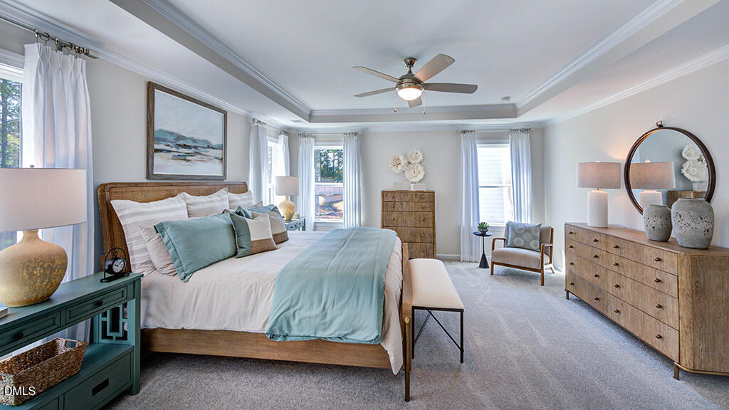 151 Rivulet Court Cary, NC 27519 - Photo 28 of 37 a spacious bedroom with a bed a dresser next to a window