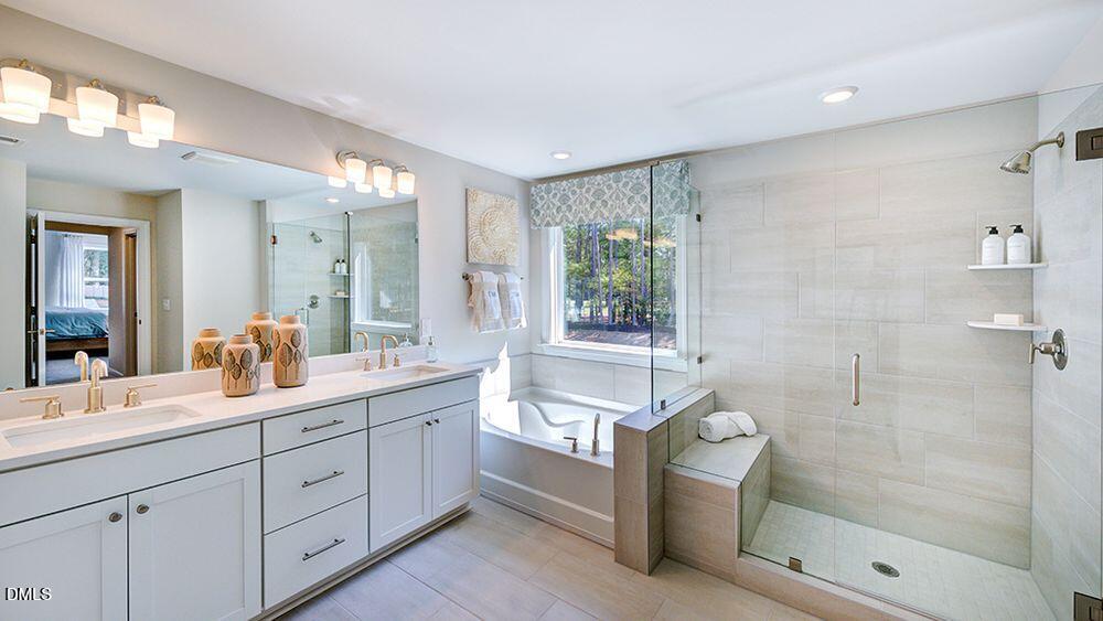 151 Rivulet Court Cary, NC 27519 - Photo 29 of 37 a spacious bathroom with a double vanity sink toilet mirror and bathtub