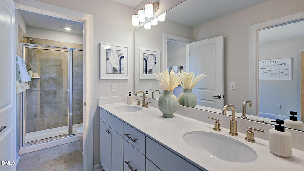151 Rivulet Court Cary, NC 27519 - Photo 35 of 37 a bathroom with a double vanity sink mirror and shower
